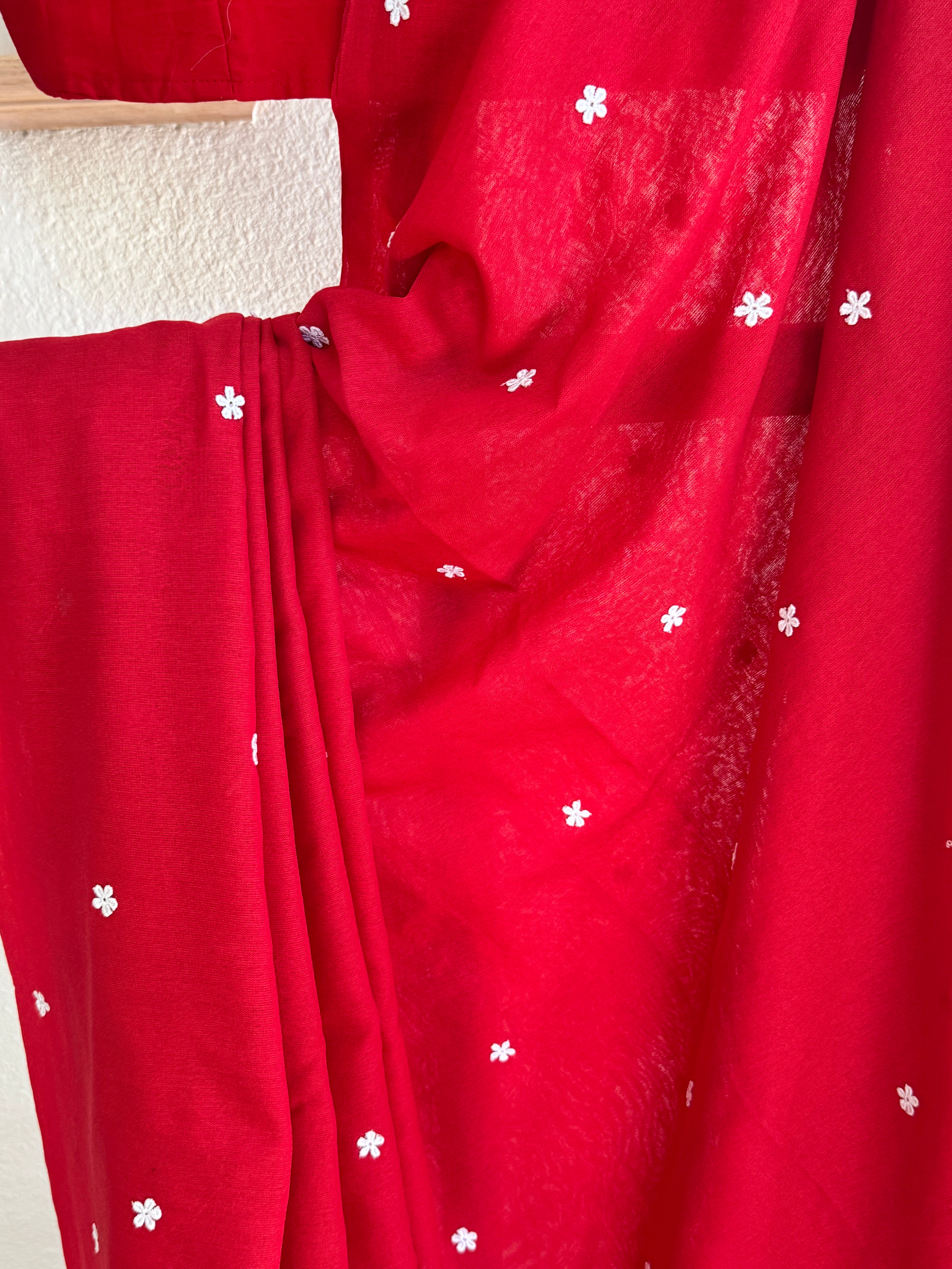 Red cotton saree with small white flowers